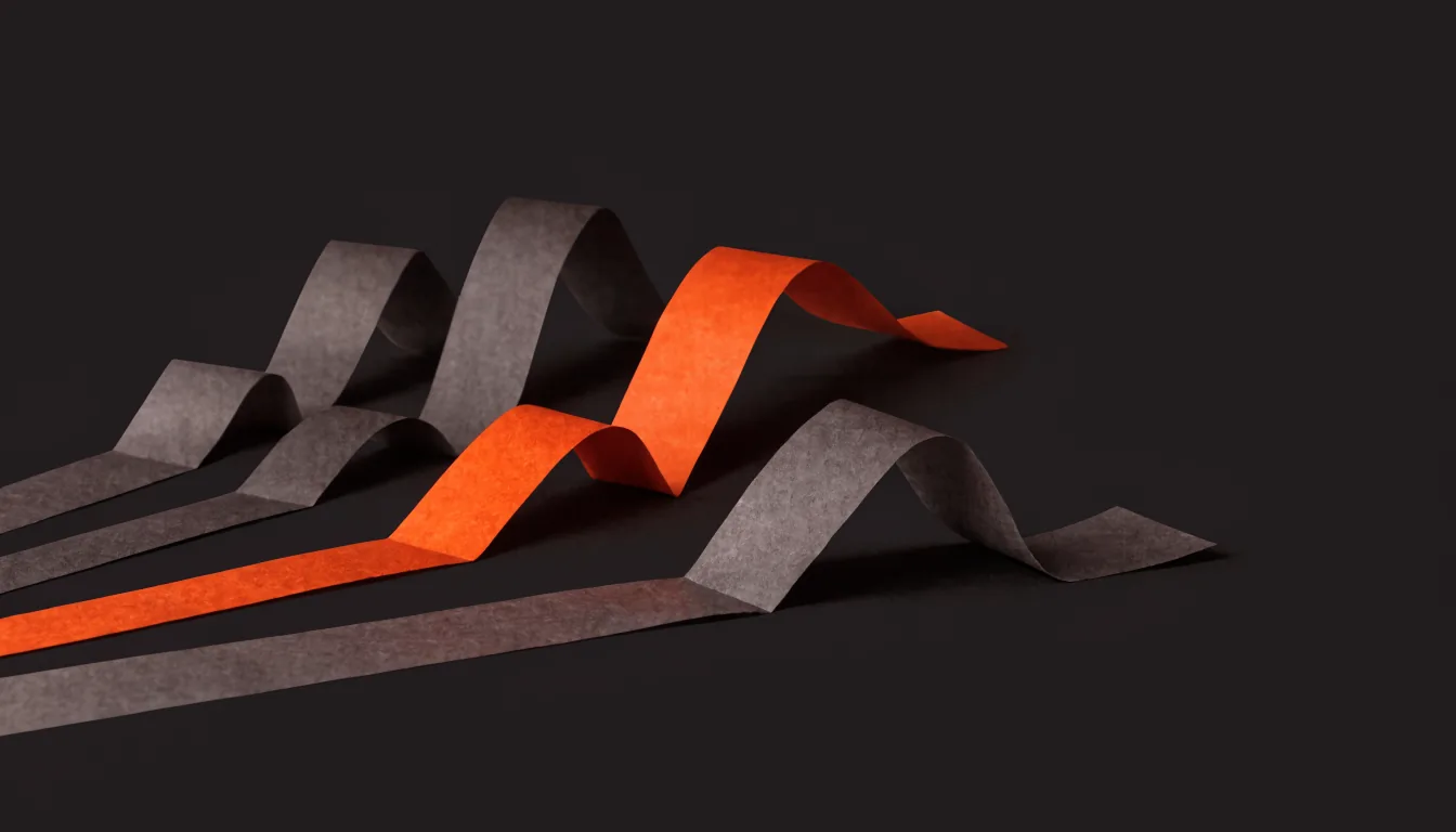 Several grey ribbons fanning across a dark surface with one orange ribbon rising and diverging from the rest, illustrating how the right marketing channel stands apart from the generic options for a given healthcare specialty.